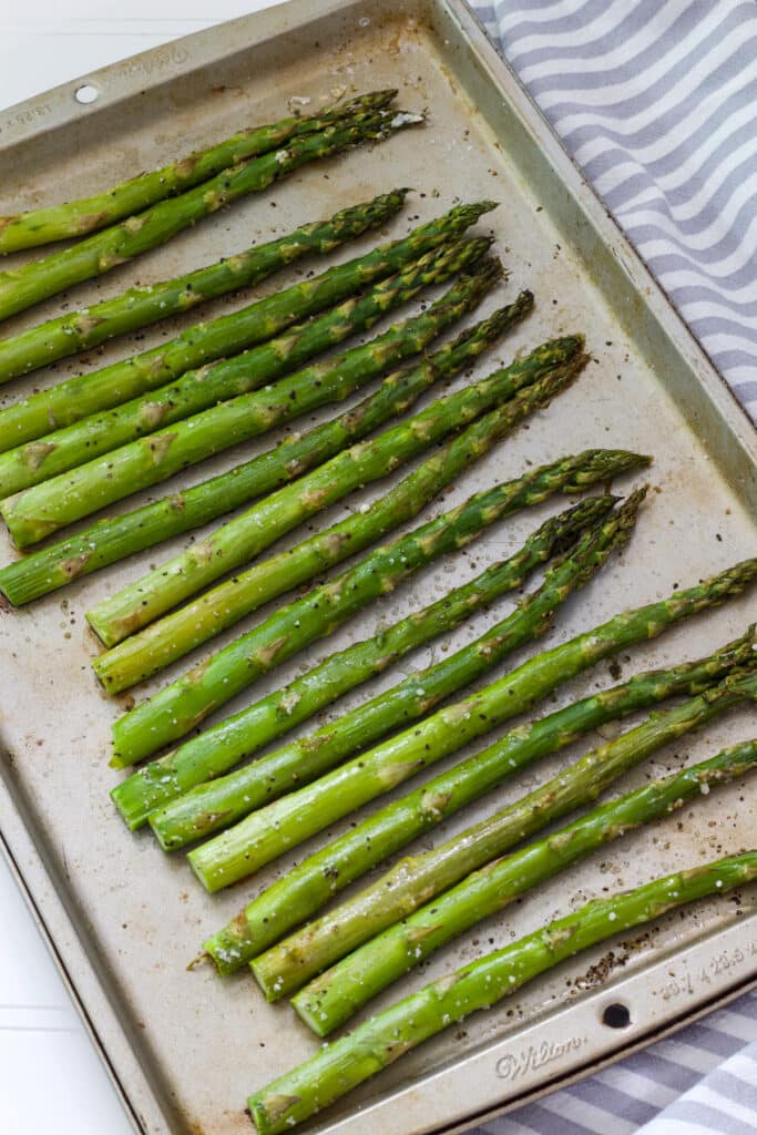 The roasted asparagus on a sheet pan after it came out of the oven.