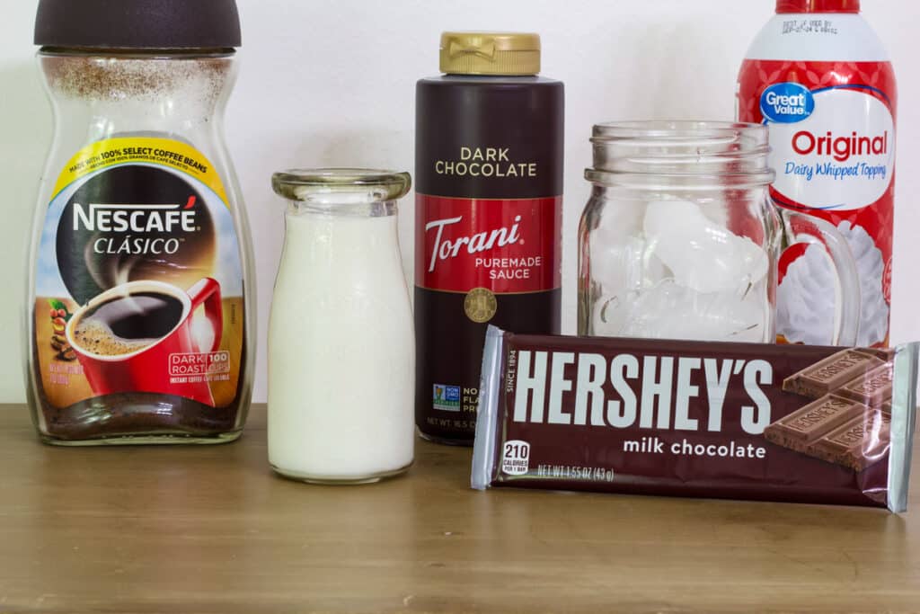 The instant coffee, milk, chocolate sauce, whipped cream, ice and a Hershey bar to make this recipe.